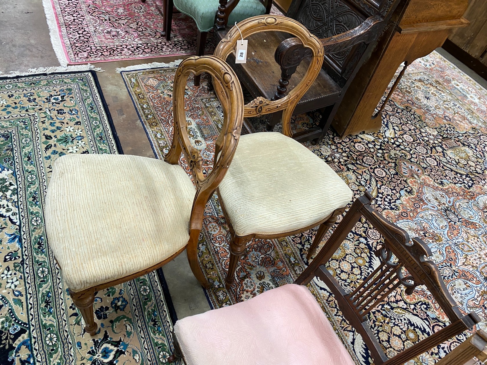 A pair of Victorian carved walnut balloon back dining chairs and a pair of late Victorian nursing chairs